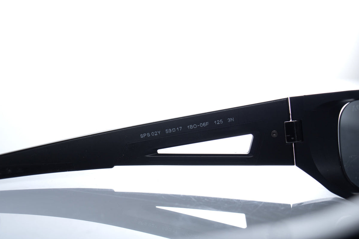 Prada, matte black sunglasses with red logo