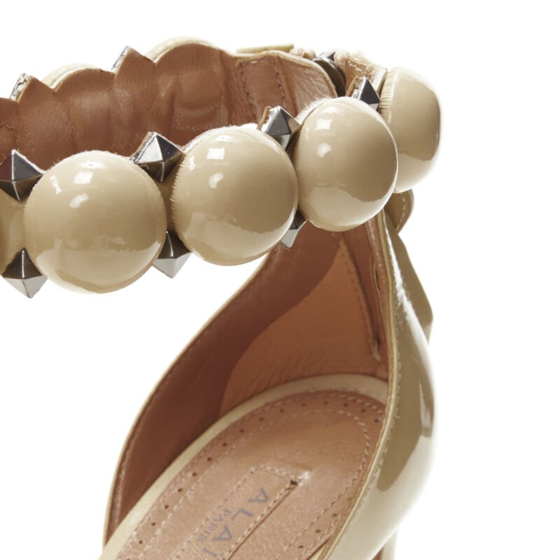 Women's Alaia La Bombe ball embellished studded patent sandal