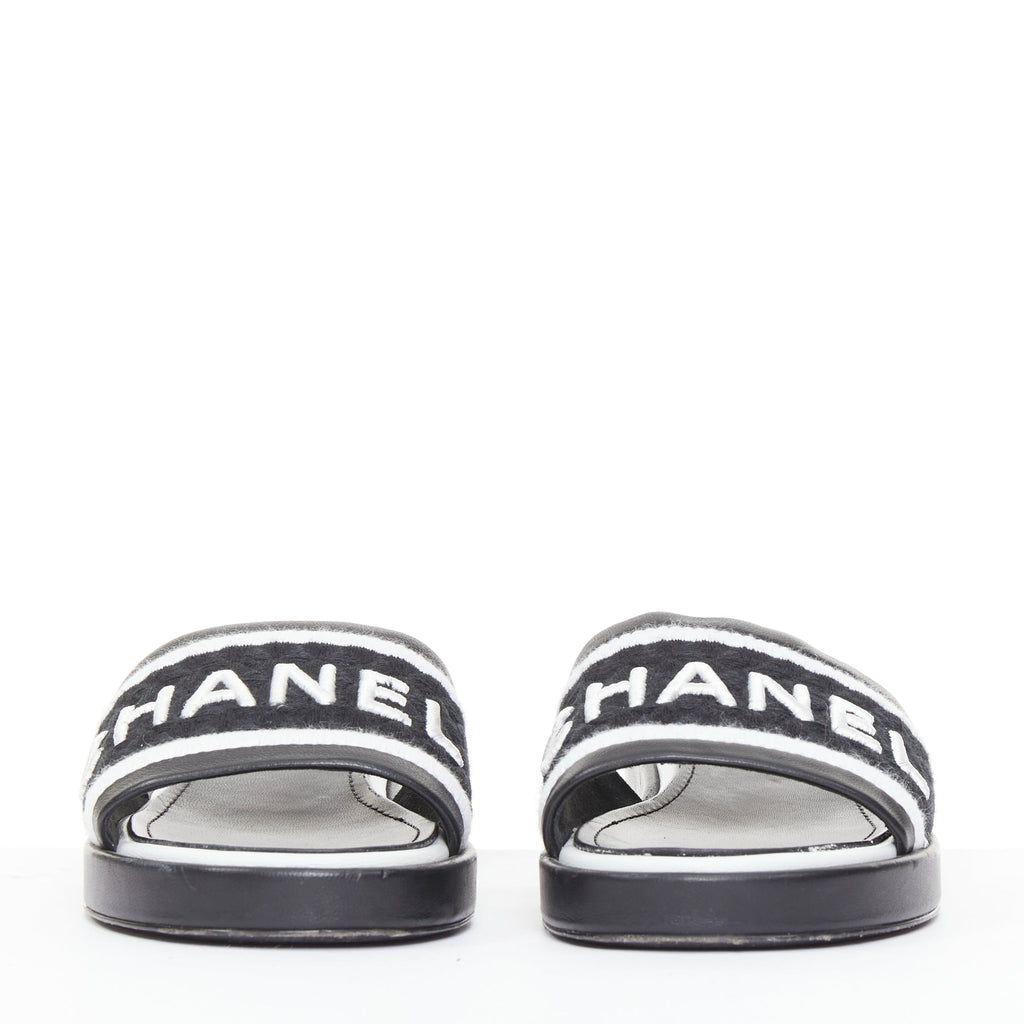 Women's Chanel black white logo embroidered lambskin heeled mules