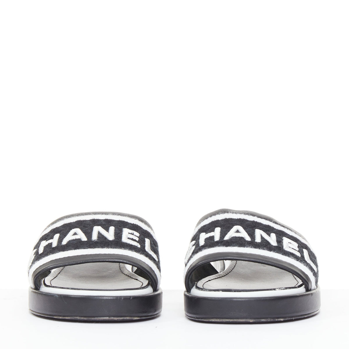 Women's Chanel black white logo embroidered lambskin heeled mules