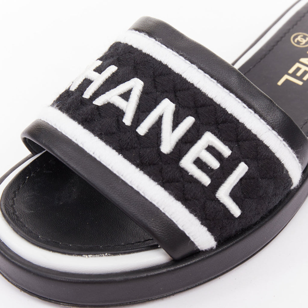 Women's Chanel black white logo embroidered lambskin heeled mules